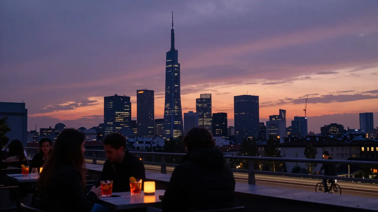 Silhouettes at a rooftop bar overlooking Milan’s skyline as the sun sets behind the Pirelli Tower.